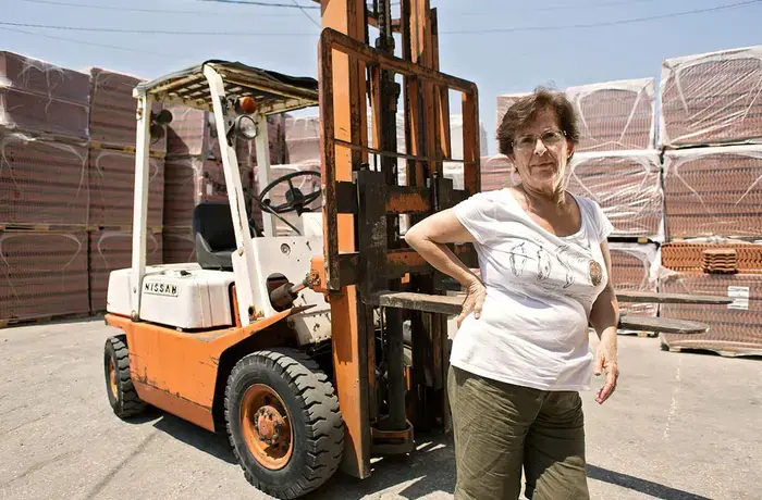 In Lebanon, Amira Abi Khalil operates a forklift to move palettes of brick. She has owned and operated her brick and stone trading company since 1997. Photo: UN Women/Joe Saad.