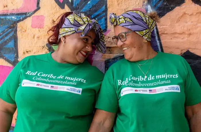 two migrant women look at each other
