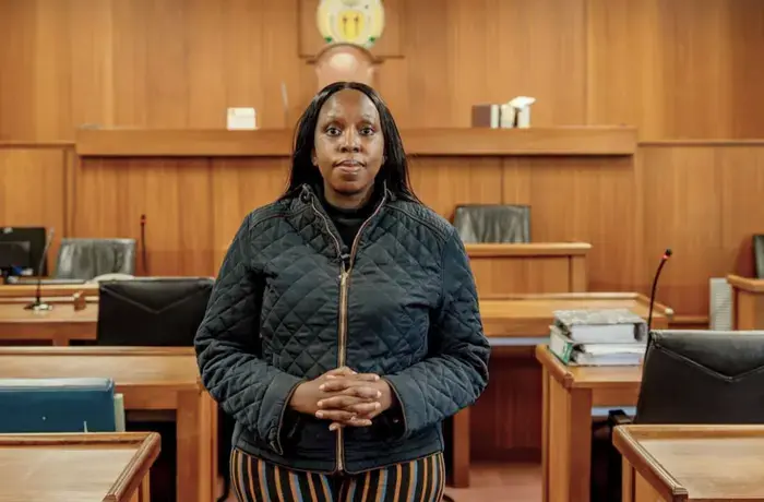 Kgomotso Modise stands in a courtroom